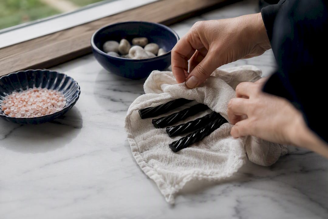 Hand wrapping damp cloth around hard licorice