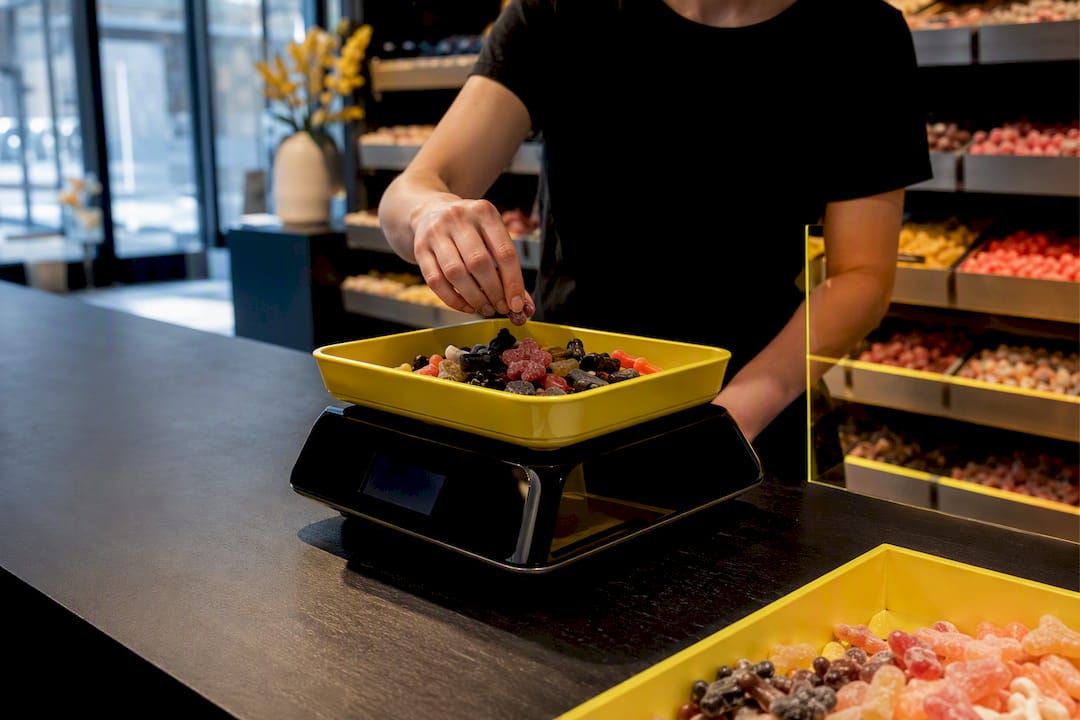 Loose candy being weighed in a shop
