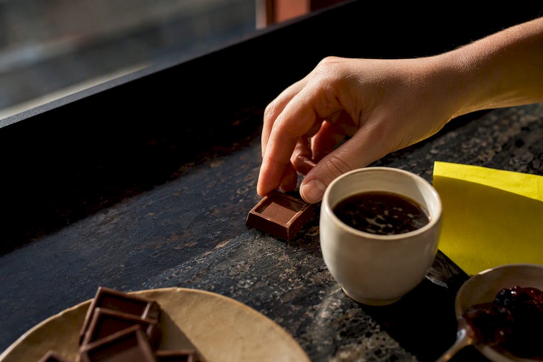 Chocolate, coffee, and berries arranged for fika