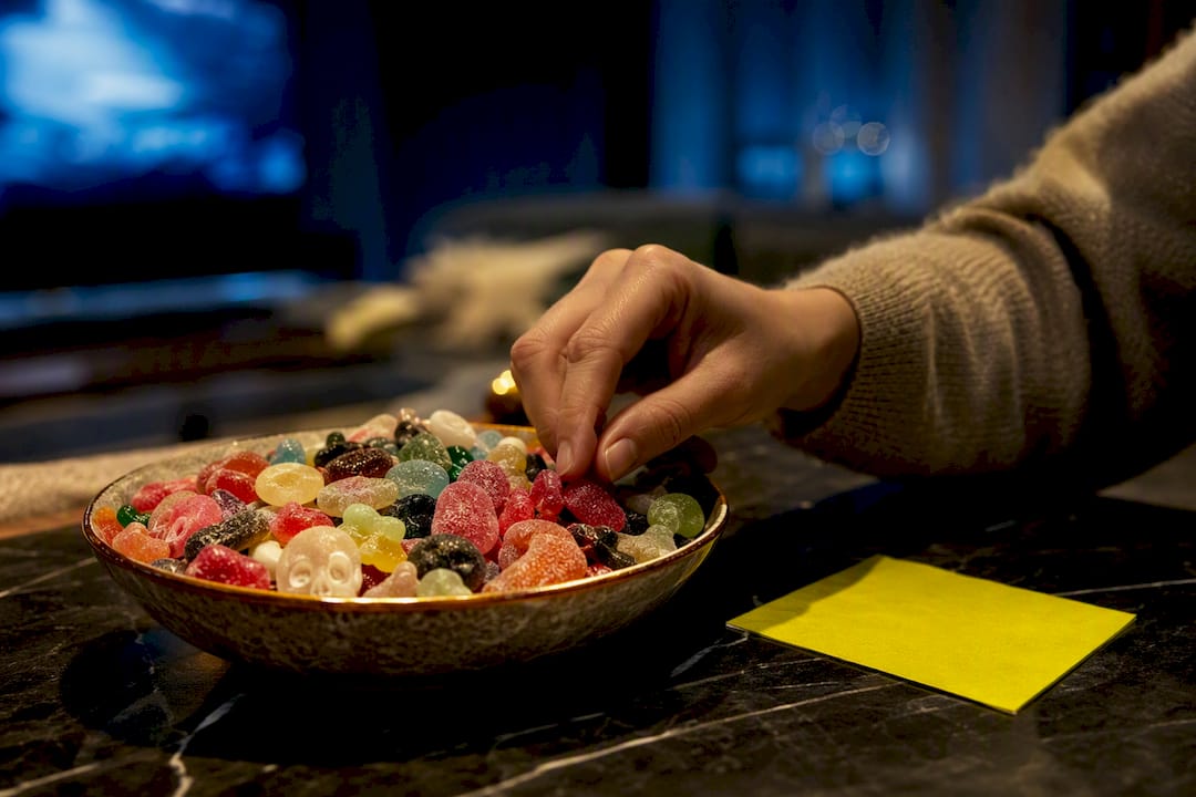 Hand reaching for candy during movie night